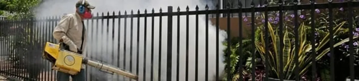 Mosquito control technician fogging a yard perimeter for mosquito reduction in Marietta, GA